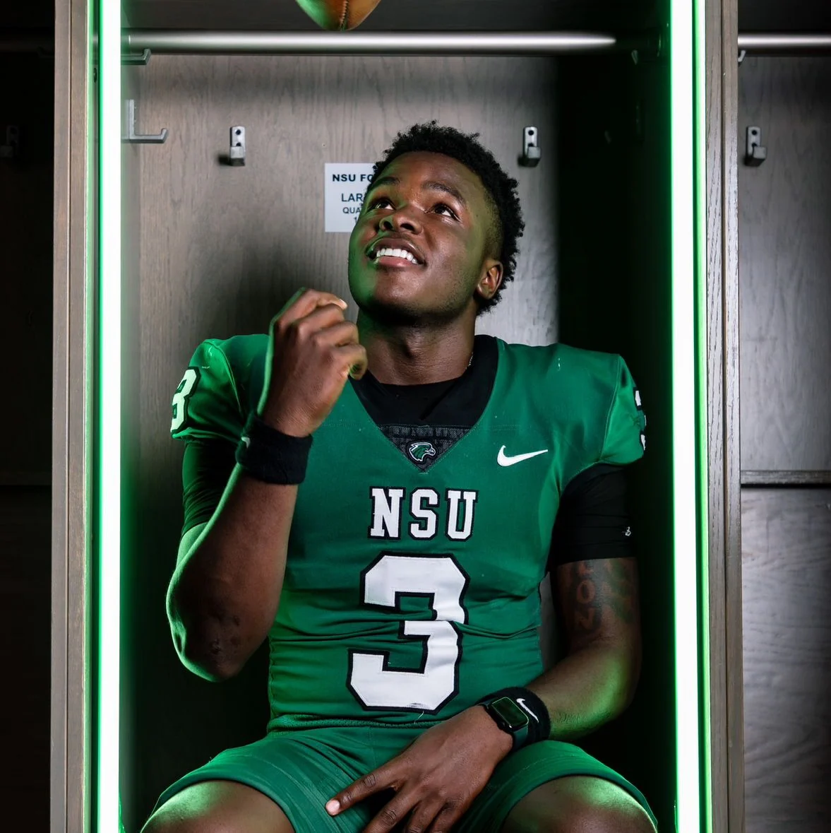 Dereun Dortch wearing his number 3 NSU football uniform in a locker room